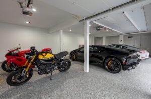Super Cars And Motorcycles In A Garage With A Gray Epoxy Floor